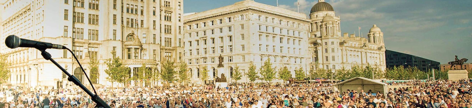 People attending open air concert in front the the Liver Building
