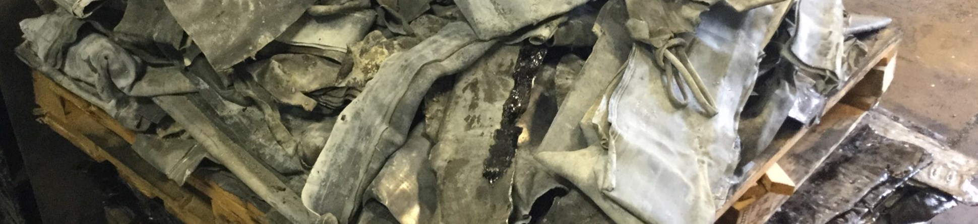 Photo of scrap lead stacked on a pallette at a recycling plant.