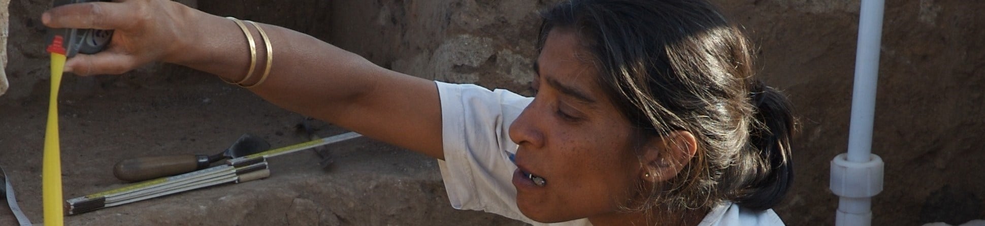 Archaeologist Shahina Farid recording and drawing features at a site.