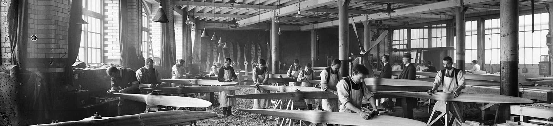 Hampton & Sons Ltd, Lambeth, London, in a wood working shop men carefully shape wooden aircraft propellers