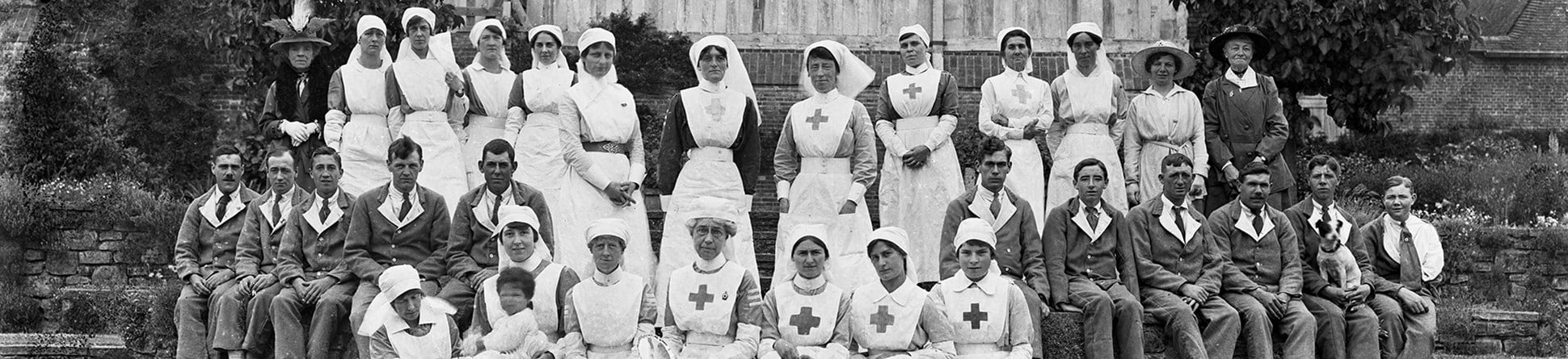 Nurses in long white uniforms with soldiers dressed in regulation convalescent uniforms at Great Dixter, East Sussex. During the war many country houses were used as hospitals and convalescent homes.