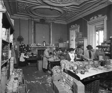 Surrey House, Marble Arch, London, 1918. Royal Flying Corps Aid Committee women are seen packing food parcels. (BL24109-002)