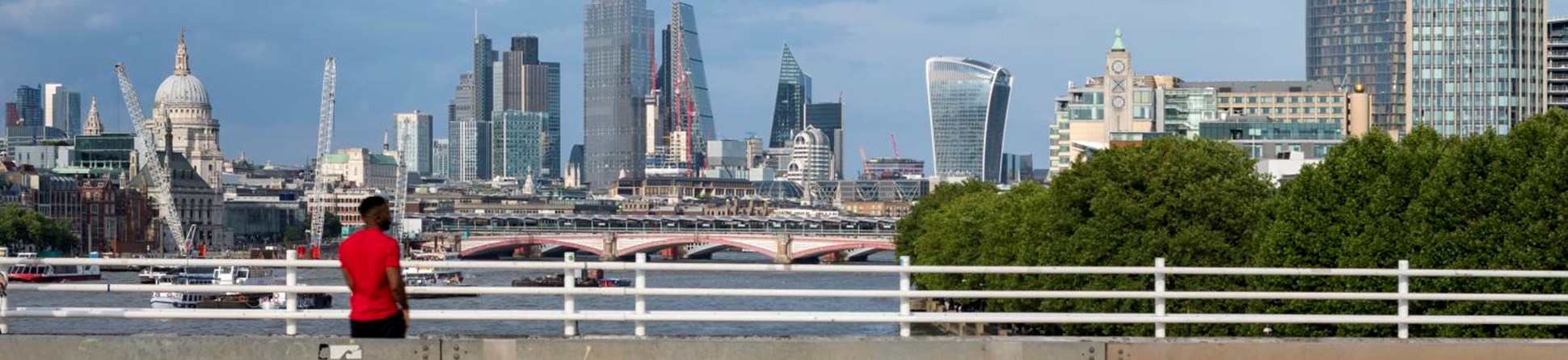 Photograph showing the view from Waterloo Bridge including St Paul's Cathedral, the skyscrapers of the City of London and the Oxo Tower in Lambeth.