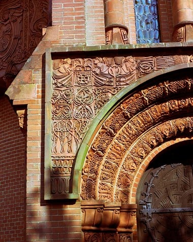 Exterior detail of a decorative doorway arch.