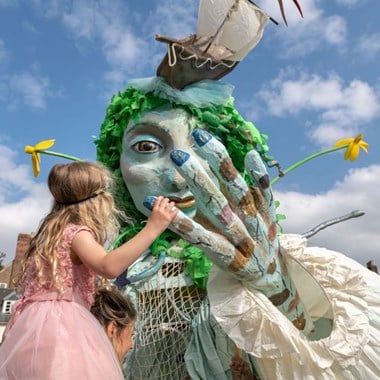 Photograph of a large blue puppet with green hair representing the Spirit of the River Severn.