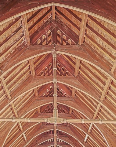 Close-up of wooden roof beams inside a church.