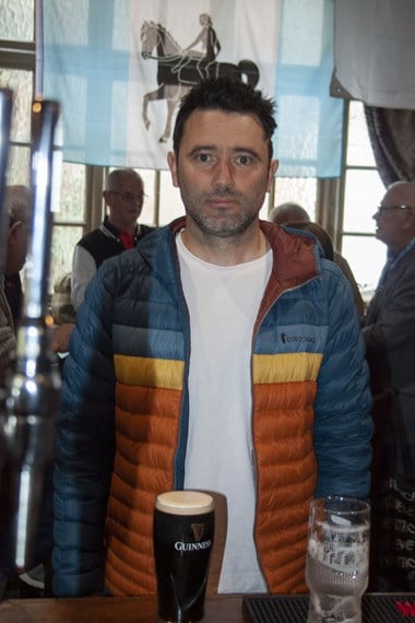Portrait of Tim Mills with a pint of Guinness, at the bar of the Coventry Cross public house