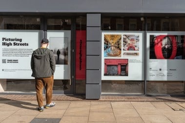 A man looking at one of the installations in a shop window