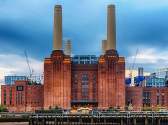 The red brick and chimneys of Battersea Power Station from across the Thames. 