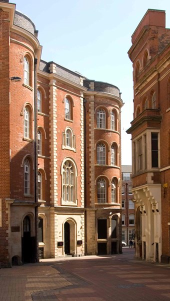 Red brick and sandstone building with arched windows