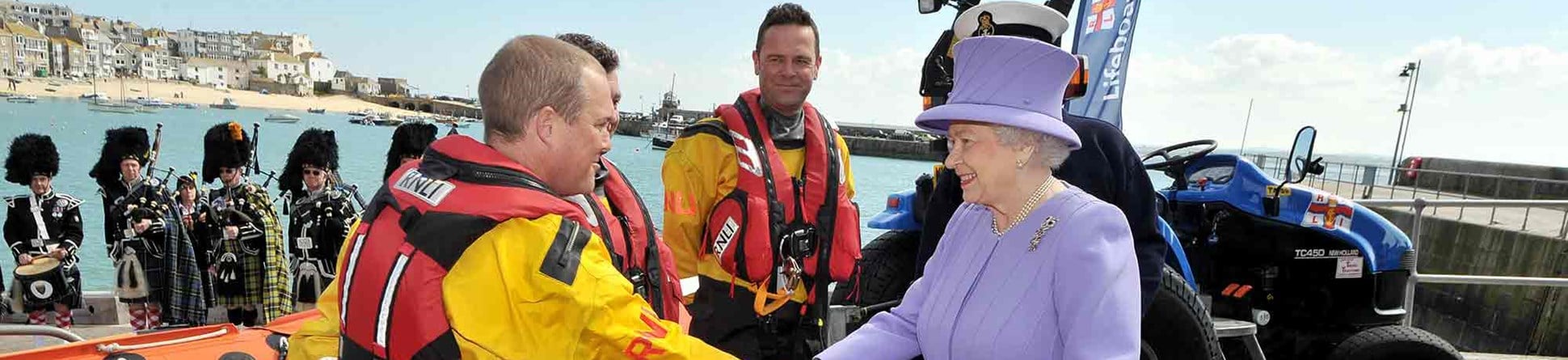 Queen Elizabeth II greets members of a lifeboat crew during a visit to the RNLI station in St Ives, Cornwall. 