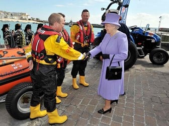 Queen Elizabeth II greets members of a lifeboat crew during a visit to the RNLI station in St Ives, Cornwall. 