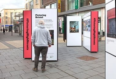 A man looking at one of the installations on the street
