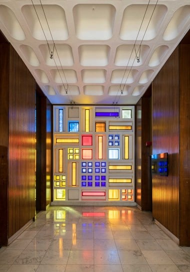 Lift foyer with coloured glass on one wall.