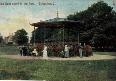 Picture of people standing around a bandstand.