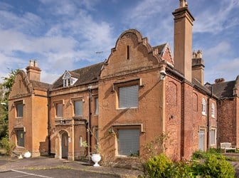 A general view of the exterior of the west front of a building with Dutch gables.