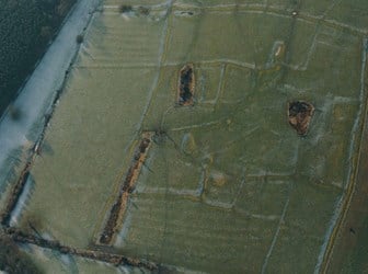 A colour aerial photograph showing a complex of earthworks.