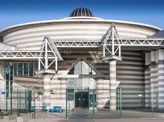 Exterior view of a leisure centre with a large domed roof structure
