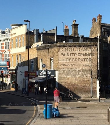 Ghost sign with wording: 'Holdaway Painter, Grainer & Decorator, estimates for general repairs'