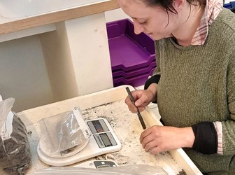 Apprentice Jackie Ann Judge weighs material in a workroom