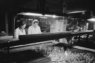 Women working on the production of glass bottles