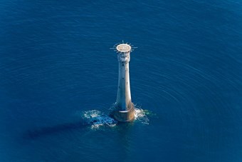 Aerial view of lighthouse in the middle of the sea
