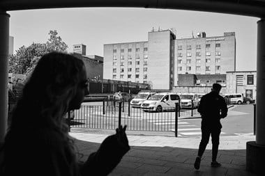A view from the Bradford Interchange looking towards the Bradford Hotel, with two people silhouetted in the foreground.