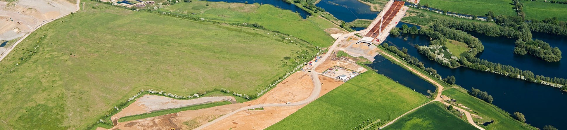 An aerial photograph showing archaeological excavations and surrounding countryside along the road improvement scheme for the A14 in Cambridgeshire, where it crosses over the Great Ouse river.